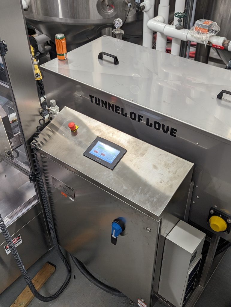 Overhead view of a tunnel of love, tunnel pasteurizer inside a beverage facility